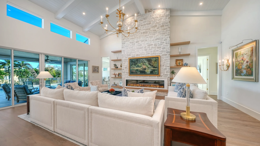 Great room with stone fireplace, clerestory windows and water views