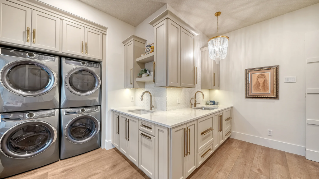 Laundry room with custom cabinetry and stacked washers and dryers