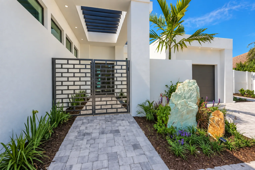 Modern custom home entry gate with landscaped garden path