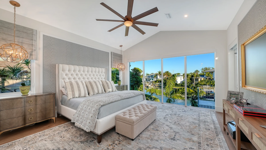 Primary bedroom with sliding glass doors and water view