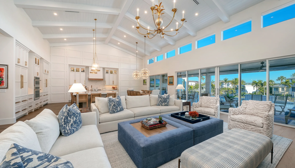 Vaulted living room with chandelier and open kitchen beyond